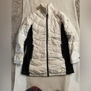 Woman’s white and black Michael kors winter coat